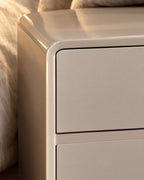 Close-up of the rounded lacquered frame and the inset drawer