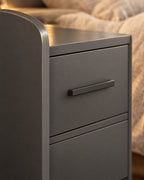 Close-up of the slim grey bar handle and the rounded side panel edge