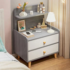 Grey bedside table with two white drawers and a raised back shelf