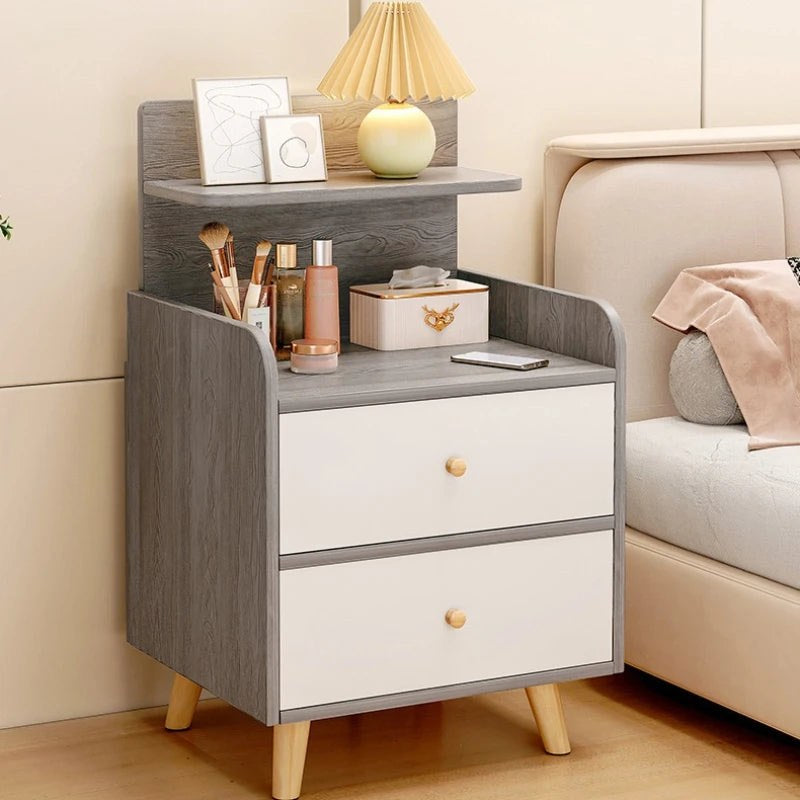 Front view of the grey bedside table with two white drawers and a raised shelf