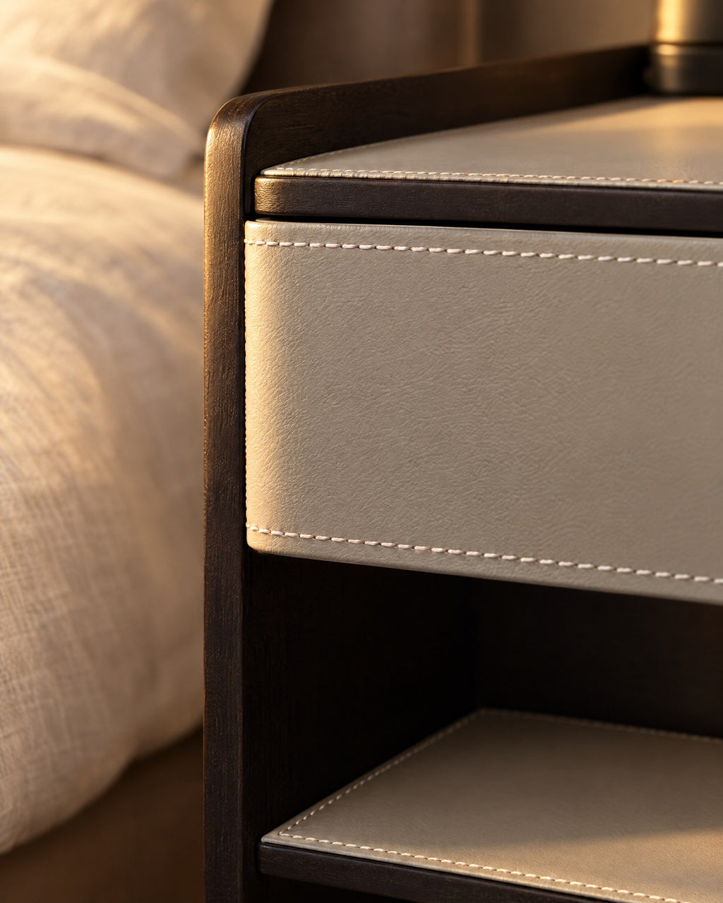 Close-up of the white contrast stitching on the light grey drawer