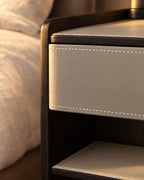 Close-up of the white contrast stitching on the light grey drawer