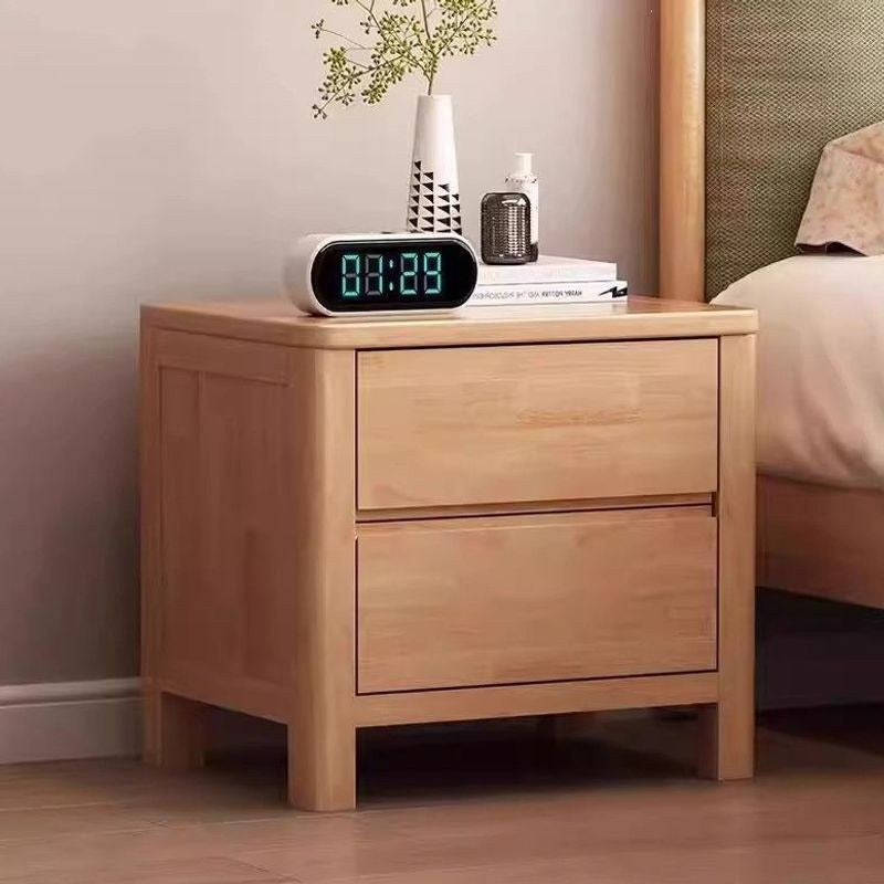 Front view of the honey wood bedside table with two drawers and square legs