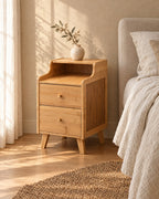 Three-quarter view of the narrow bamboo bedside table showing the splayed legs