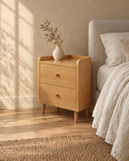 Three-quarter view of the narrow cherry bedside table showing the raised rim and tapered legs