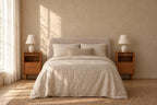 Pair of narrow cherry wood bedside tables on each side of a double bed