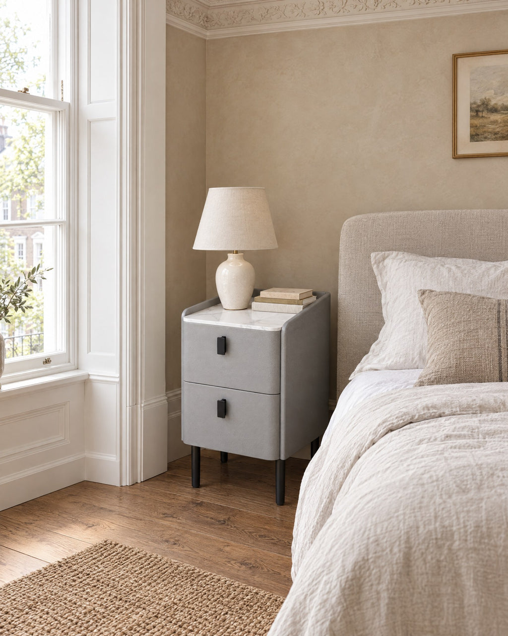Narrow Grey Bedside Table beside a linen bed in a bright British bedroom with a sash window