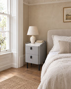 Narrow Grey Bedside Table beside a linen bed in a bright British bedroom with a sash window