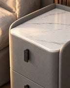 Close-up of the marble-effect top, raised lip and black drawer handle