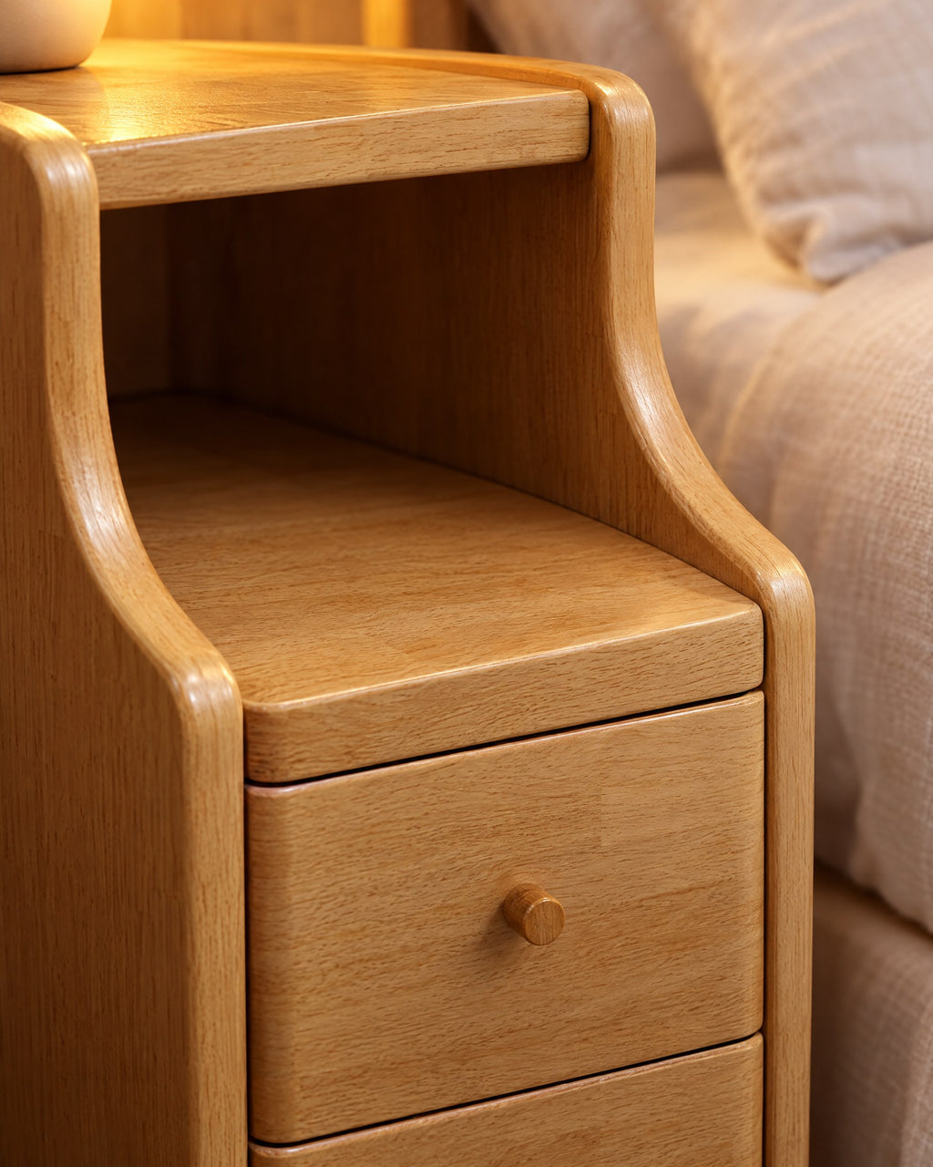 Close-up of the open niche and the round wooden drawer knob in natural rubberwood