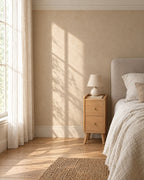 Narrow 20 cm oak-effect bedside table beside a linen bed in a British bedroom with a sash window