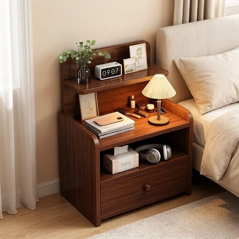 Narrow walnut bedside table with a raised shelf, open cubby and one drawer