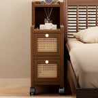 Narrow walnut bedside cabinet with two rattan drawers beside a bed