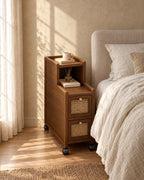 Narrow walnut bedside cabinet with rattan drawers in morning light