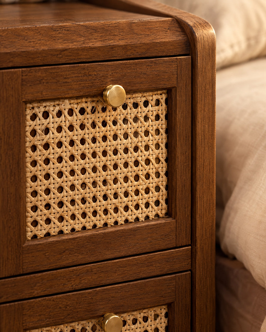 Close-up of the woven rattan drawer front and brass knob