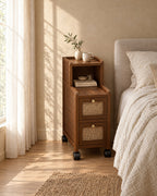 Narrow walnut bedside cabinet on wheels in warm morning light