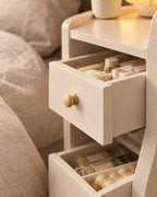 Close-up of an open drawer and its round wooden knob