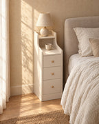 Three-quarter view of the narrow white bedside table showing its two-level top