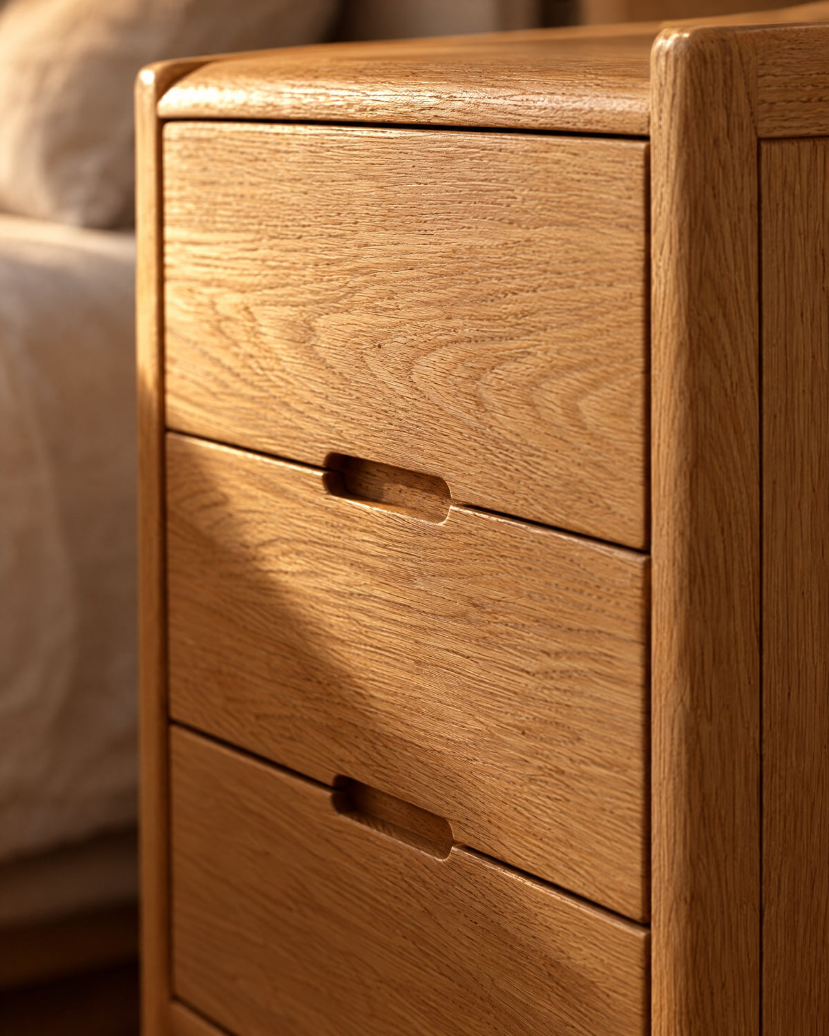 Close-up of the oak grain and the recessed finger pull of a drawer