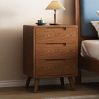 Oak bedside table with three drawers, front view