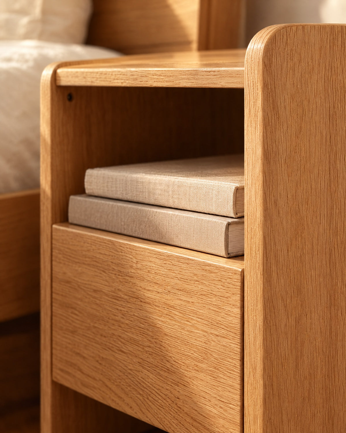Close-up detail of the oak bedside table with an open shelf and one drawer
