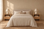 Two oak bedside tables with an open shelf and one drawer on each side of a double bed