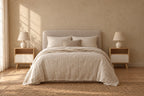 Pair of oak-effect bedside tables with open niche and white drawer on each side of a double bed