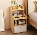 Oak-effect bedside table with open shelves and a lockable drawer in a bedroom