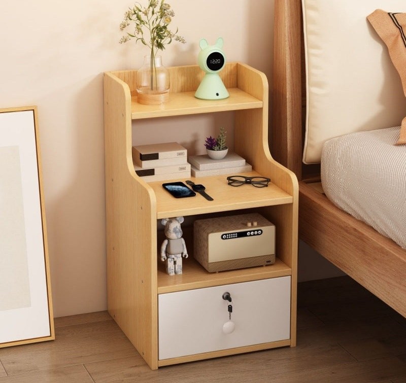 Oak-effect bedside table with open shelves and a lockable drawer in a bedroom