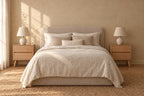 Two oak bedside tables with two drawers and tapered legs on each side of a double bed