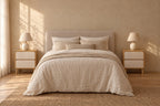Pair of oak and cream bedside tables with two handle-free drawers on each side of a double bed