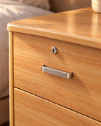 Close-up of the key lock and brushed metal bar handle on the top drawer