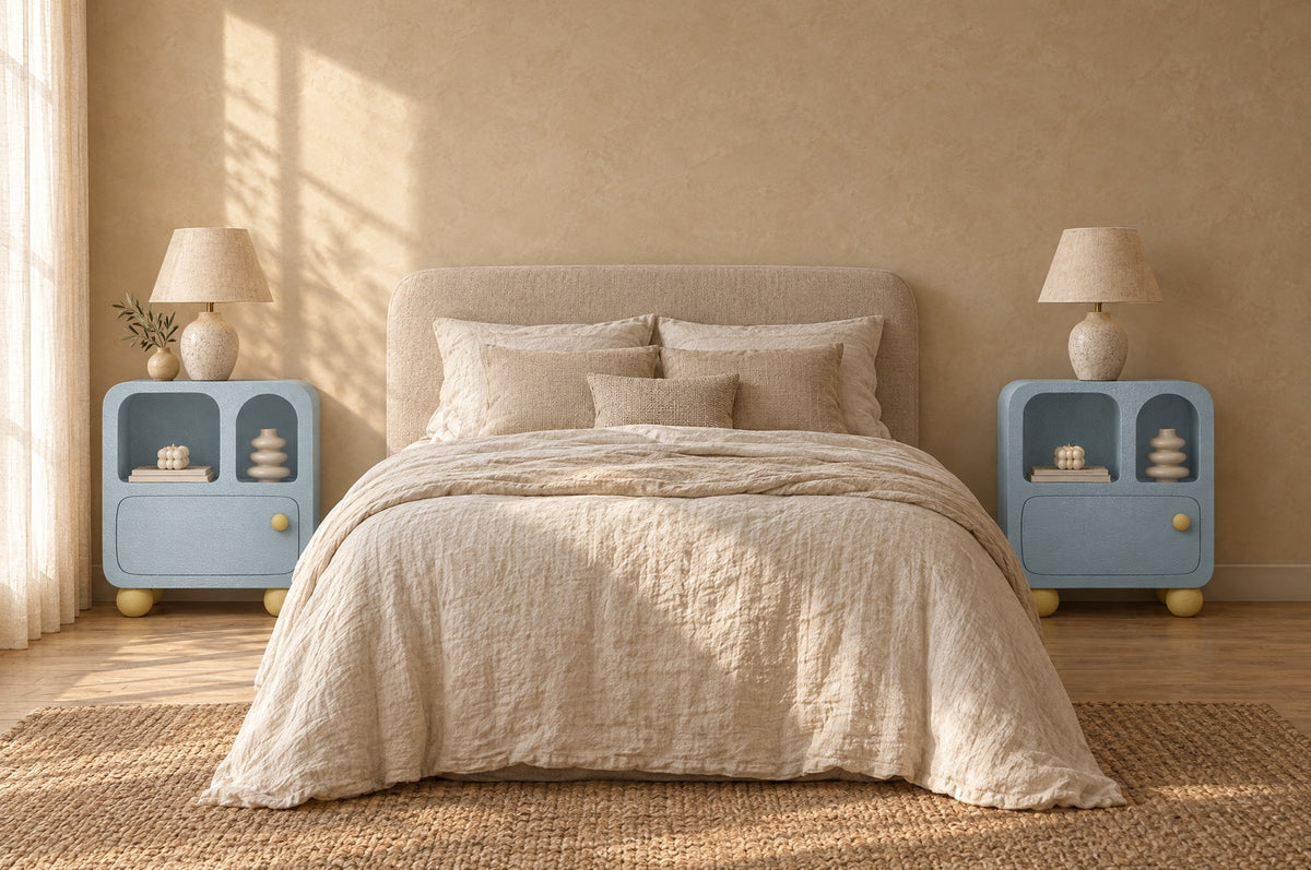 Pair of pastel blue bedside cabinets with arched niches on each side of a double bed