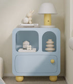 Pastel blue bedside cabinet with arched niches in a bedroom