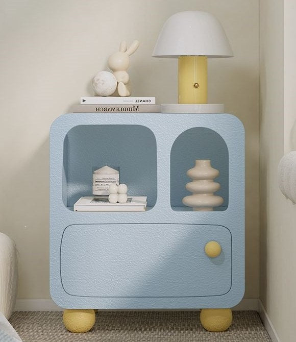 Pastel blue bedside cabinet with arched niches in a bedroom