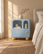 Three-quarter view of the pastel blue bedside cabinet with arched niches
