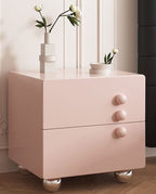 Front view of the pink Bedside Table with 2 Drawers, Round Knobs and Ball Feet