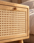 Close-up of the woven cane drawer front and its round wooden knob