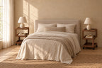 Pair of walnut-effect rolling bedside tables with three open tiers on each side of a double bed