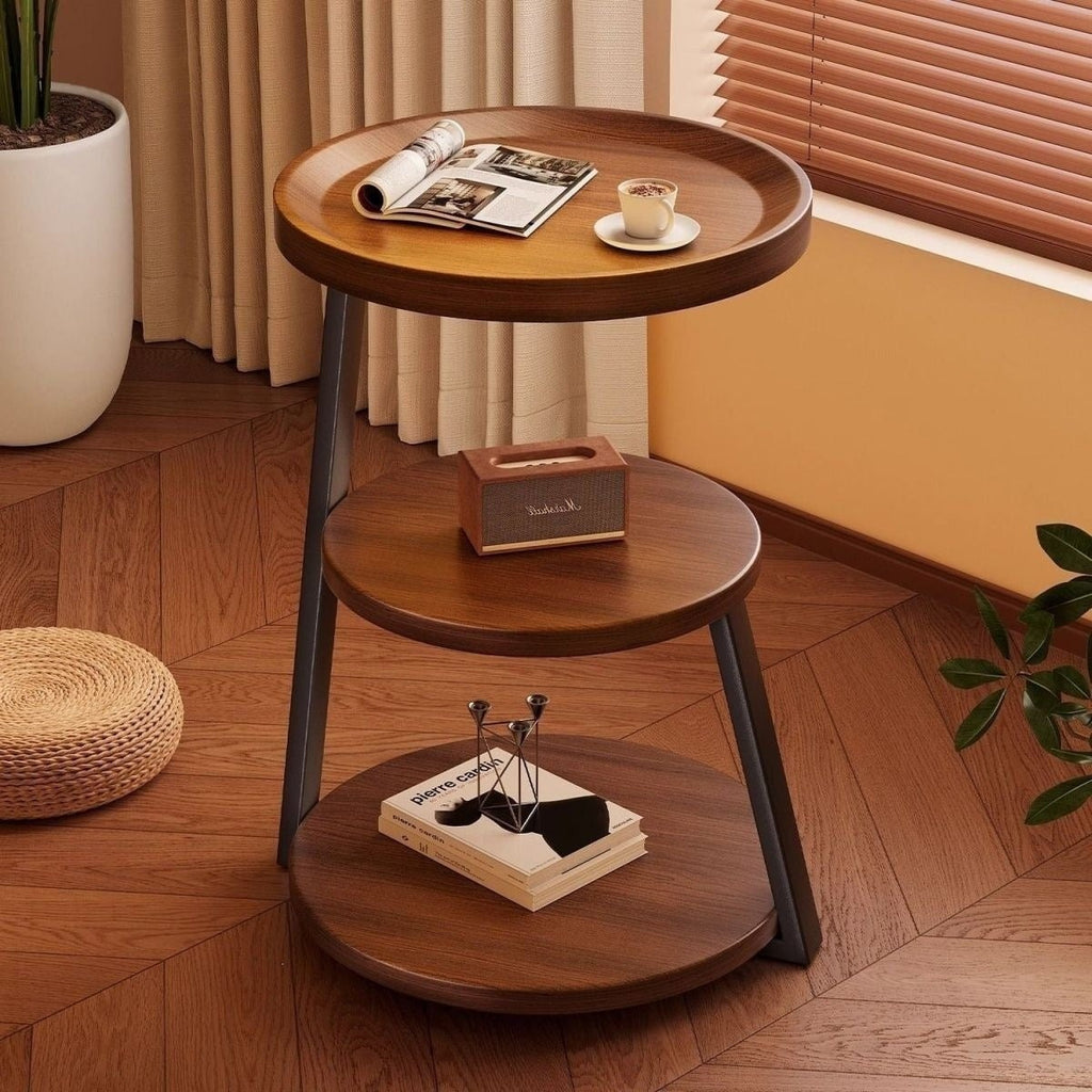 Front view of the round three-tier walnut-tone bedside table with black metal legs