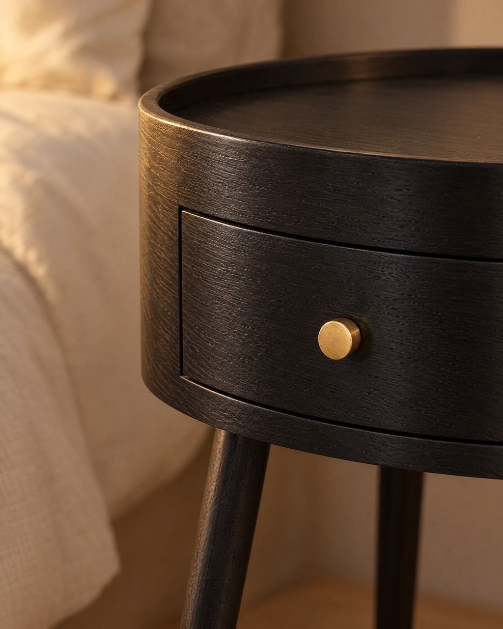 Close-up of the curved drawer and its small brass knob