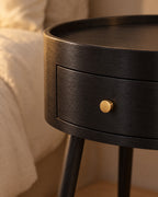 Close-up of the curved drawer and its small brass knob
