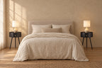 Pair of round black bedside tabless with drawer on each side of a double bed