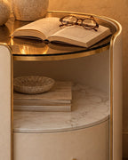 Close-up of the tinted glass top, gold trim and marble-effect shelf