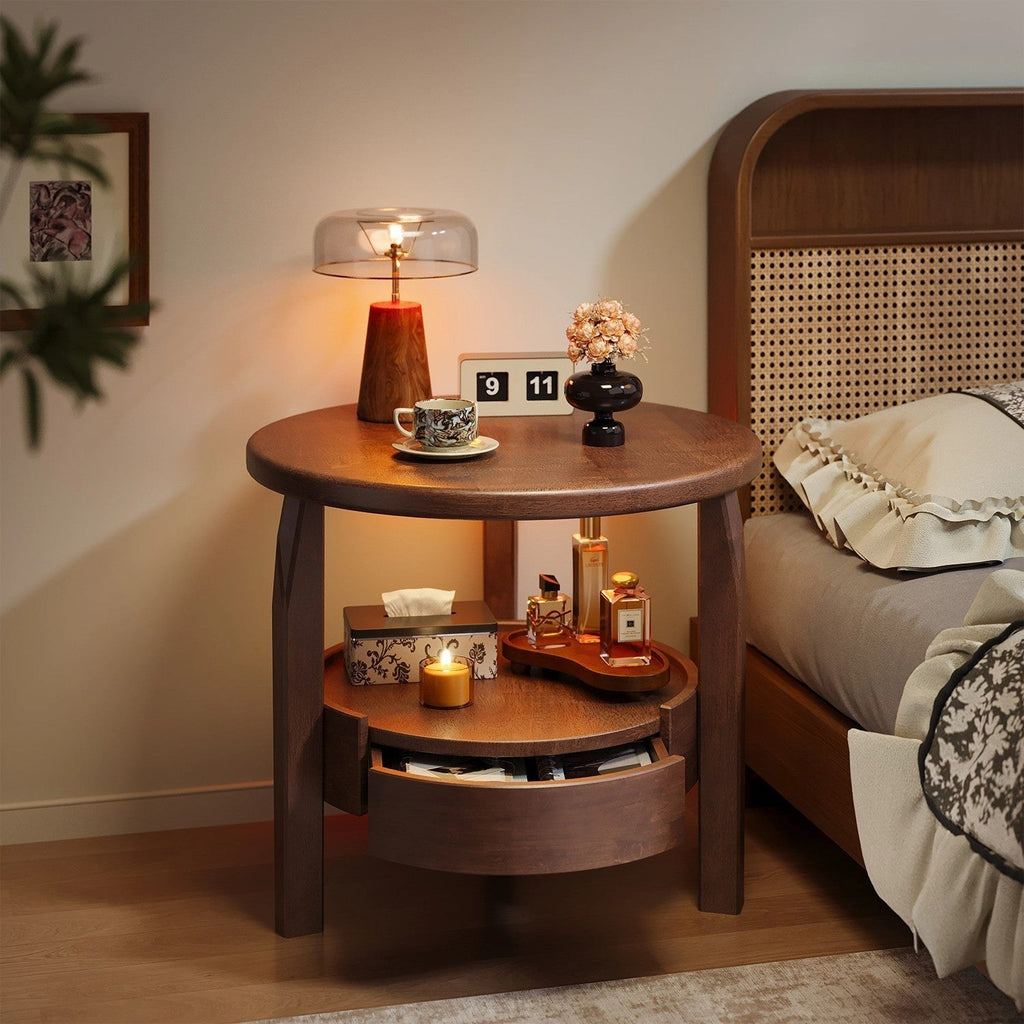 Round walnut-tone bedside table with three legs, supplier photograph