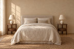 Pair of round walnut-tone bedside tables on each side of a double bed
