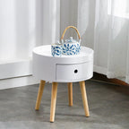 Round white bedside table with natural wood legs, supplier product photo