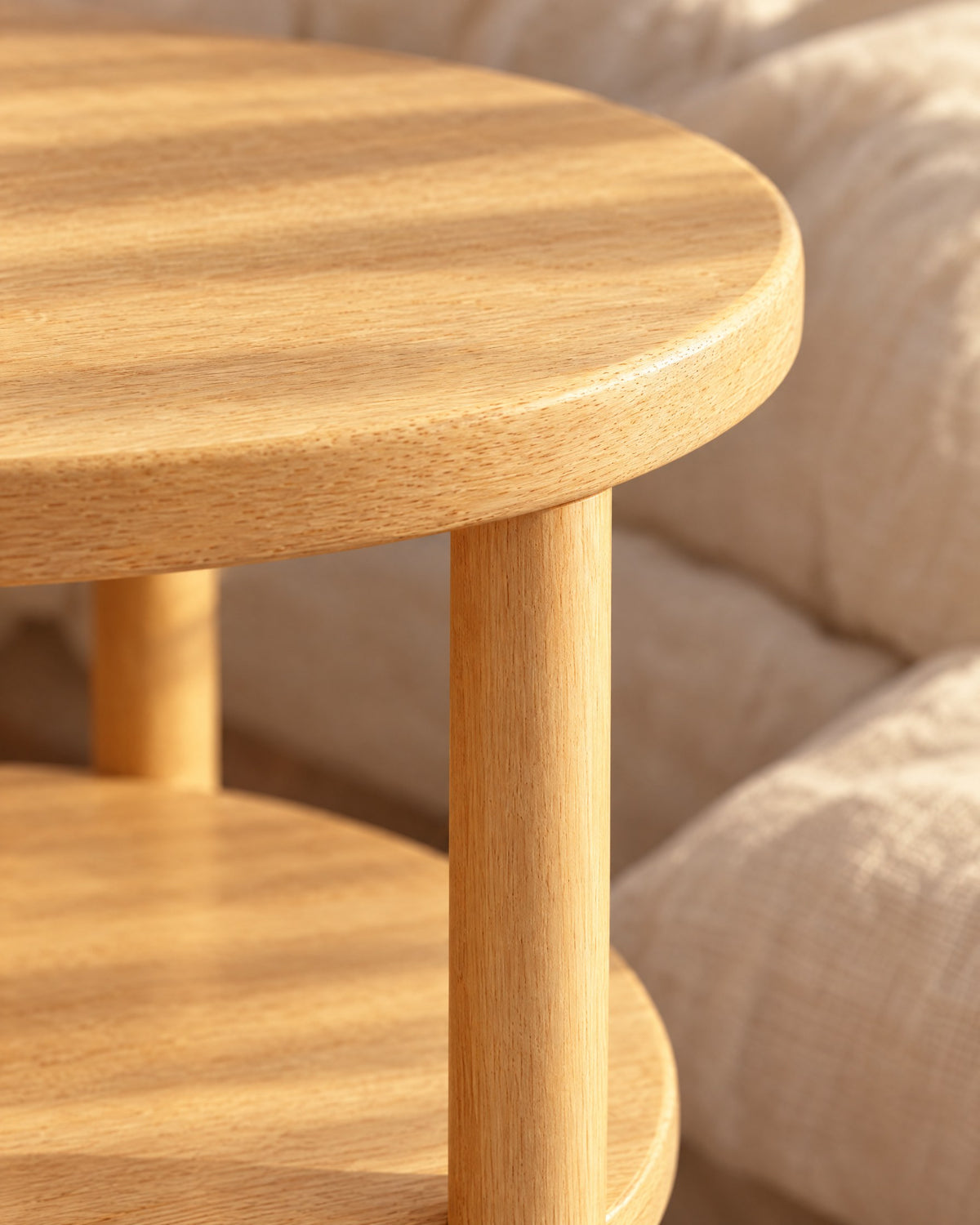 Close-up detail of the round two-tier wooden bedside table
