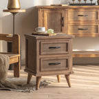 Rustic wood bedside table with herringbone drawers in a bedroom