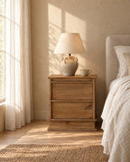 Rustic wood bedside table on a plinth base in warm morning light